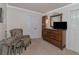 Bedroom with an upholstered chair, dresser, and decorative mirror for a comfortable retreat at 15440 County Road 675, Parrish, FL 34219