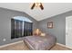 Inviting bedroom showcasing a vaulted ceiling, gray walls, a tiled floor, and a sunny window at 15440 County Road 675, Parrish, FL 34219