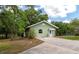 Quaint single-story house with well-maintained lawn, surrounded by mature trees and offering serene outdoor space at 15440 County Road 675, Parrish, FL 34219