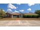 Charming single-story home features solar panels, manicured lawn, brick accents, and inviting front porch at 15440 County Road 675, Parrish, FL 34219