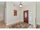 Inviting foyer with tile flooring, decorative rug, and a classic wooden door with sidelights enhancing the home's entry at 15440 County Road 675, Parrish, FL 34219