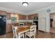 Kitchen with a wood dining table, appliances, wood cabinets, and view to backyard from window at 15440 County Road 675, Parrish, FL 34219