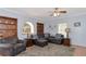 Living room with plush sofa, armchair, built-in shelves, and a decorative rug for a cozy feel at 15440 County Road 675, Parrish, FL 34219