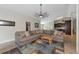 Spacious living room with tile floors, comfortable sectional sofa, and access to the kitchen area. with a ceiling fan at 15440 County Road 675, Parrish, FL 34219