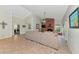 Open living room with a brick fireplace, comfortable sofa, tile flooring, and access to other areas of the home at 15440 County Road 675, Parrish, FL 34219