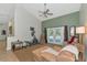 Bright living room with vaulted ceilings, French doors, and comfortable seating and a ceiling fan for extra comfort at 15440 County Road 675, Parrish, FL 34219