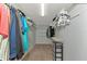 Walk-in closet with neutral-colored walls, carpet, wire shelves, clothing, and a built-in storage tower at 15440 County Road 675, Parrish, FL 34219