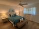 Cozy bedroom with a ceiling fan, wood flooring, and ample natural light from the window at 1553 Stewart Dr # 513, Sarasota, FL 34232
