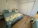 Relaxing bedroom with wood floors, a ceiling fan and spacious closet with doors at 1553 Stewart Dr # 513, Sarasota, FL 34232
