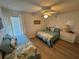 Inviting bedroom with two beds, wood flooring, and a ceiling fan at 1553 Stewart Dr # 513, Sarasota, FL 34232