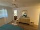 Comfortable bedroom featuring wood floors, a dresser, and a ceiling fan at 1553 Stewart Dr # 513, Sarasota, FL 34232