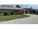 Well-maintained one story villa with lush green lawn and landscaping at 1553 Stewart Dr # 513, Sarasota, FL 34232