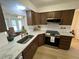 Modern kitchen featuring stainless steel appliances, marble countertops, and wood-look cabinets at 1553 Stewart Dr # 513, Sarasota, FL 34232