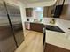 Bright kitchen with stainless steel appliances, updated cabinets, and elegant countertops at 1553 Stewart Dr # 513, Sarasota, FL 34232