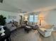 Comfortable living room area staged with area rug, ceiling fan and lamps at 1553 Stewart Dr # 513, Sarasota, FL 34232