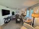 A comfortable living room features neutral paint, ceiling fan and flat screen TV at 1553 Stewart Dr # 513, Sarasota, FL 34232
