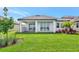 Well-maintained backyard has a lush lawn and covered patio with large glass doors, perfect for enjoying the outdoors at 17333 Savory Mist Cir, Bradenton, FL 34211