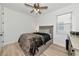 Bedroom features wood floors, ceiling fan, window, and neutral decor at 17333 Savory Mist Cir, Bradenton, FL 34211