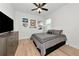 Bedroom with wood floors, ceiling fan, dresser, and decor at 17333 Savory Mist Cir, Bradenton, FL 34211