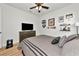 Bedroom featuring wood floors, ceiling fan, dresser, and decor at 17333 Savory Mist Cir, Bradenton, FL 34211