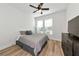 Comfortable bedroom with two windows, ceiling fan and wood-look floors at 17333 Savory Mist Cir, Bradenton, FL 34211