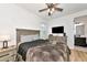 Bedroom features wood floors, ceiling fan, dresser and en suite bathroom at 17333 Savory Mist Cir, Bradenton, FL 34211