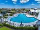 Beautiful community pool featuring lounge chairs, palm trees, and ample recreational space at 17333 Savory Mist Cir, Bradenton, FL 34211