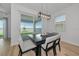 Elegant dining area with modern light fixture and access to outdoor patio at 17333 Savory Mist Cir, Bradenton, FL 34211