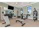 Fully-equipped fitness center with weight machines, free weights, and mirrors, perfect for a complete workout at 17333 Savory Mist Cir, Bradenton, FL 34211