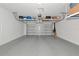 Clean and organized two-car garage with epoxy flooring and overhead storage racks providing extra space at 17333 Savory Mist Cir, Bradenton, FL 34211