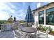 Outdoor grilling area with a built-in grill, seating, and umbrella, perfect for community gatherings at 17333 Savory Mist Cir, Bradenton, FL 34211