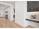 Hallway features wood floors, an accent wall, and leads to the entryway and the rest of the home at 17333 Savory Mist Cir, Bradenton, FL 34211