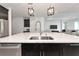 Kitchen island with a sink, barstool seating, stainless steel appliances, and dark wood cabinets at 17333 Savory Mist Cir, Bradenton, FL 34211
