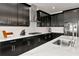 Modern kitchen with white countertops, dark cabinets, stainless steel appliances, and tile backsplash at 17333 Savory Mist Cir, Bradenton, FL 34211