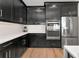 Modern kitchen with stainless steel appliances, and custom black cabinets at 17333 Savory Mist Cir, Bradenton, FL 34211