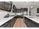 Modern kitchen with stainless steel appliances, dark wood cabinets, light countertops, and wood floors at 17333 Savory Mist Cir, Bradenton, FL 34211