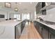 Open-concept kitchen showcases long island, dark cabinets, and stainless appliances at 17333 Savory Mist Cir, Bradenton, FL 34211