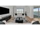 Stylish living room offers comfortable seating and a view of the water at 17333 Savory Mist Cir, Bradenton, FL 34211