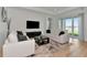 Bright living room boasts modern decor, neutral colors and sliding doors at 17333 Savory Mist Cir, Bradenton, FL 34211