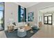 Bright living room with large windows, a comfortable white sofa, and stylish decor at 17333 Savory Mist Cir, Bradenton, FL 34211