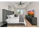 Stylish bedroom with tray ceiling, wood-look floors, and plenty of natural light through large windows at 17333 Savory Mist Cir, Bradenton, FL 34211