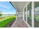 This is an eye-level view of the covered patio with brick pavers and a lovely view of the lake at 17333 Savory Mist Cir, Bradenton, FL 34211