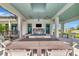 Inviting outdoor patio with comfortable seating, a fireplace, and a TV, ideal for relaxation at 17333 Savory Mist Cir, Bradenton, FL 34211