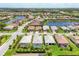 An aerial view shows homes surrounding a lake, showcasing the community's layout and attractive water features at 17910 Waterville Pl, Lakewood Ranch, FL 34202