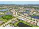 Expansive aerial view of a well-planned community with houses nestled around picturesque lakes and green spaces at 17910 Waterville Pl, Lakewood Ranch, FL 34202