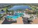 Aerial view of a sprawling community pool, lake, and recreation area in a scenic neighborhood at 17910 Waterville Pl, Lakewood Ranch, FL 34202