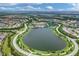 Expansive aerial shot of the community showcasing the lake, lush landscaping, and residential layout at 17910 Waterville Pl, Lakewood Ranch, FL 34202