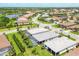 Beautiful aerial view of homes in a meticulously landscaped neighborhood with lakes and lush greenery at 17910 Waterville Pl, Lakewood Ranch, FL 34202