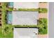 Aerial view of the property with a screened-in pool and lush landscaping at 17910 Waterville Pl, Lakewood Ranch, FL 34202