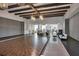 Spacious ballroom featuring wood floors, exposed beam ceilings, elegant lighting, and stylish decor for events at 17910 Waterville Pl, Lakewood Ranch, FL 34202